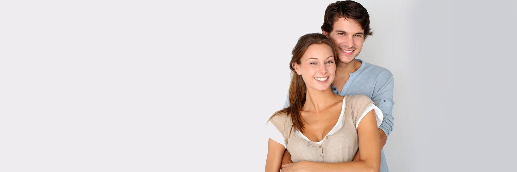 Young couple smiling & hugging l KOR Teeth Whitening NYC